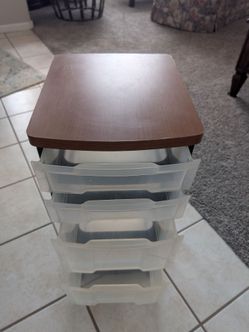 Four drawer plastic storage tower with wheels.