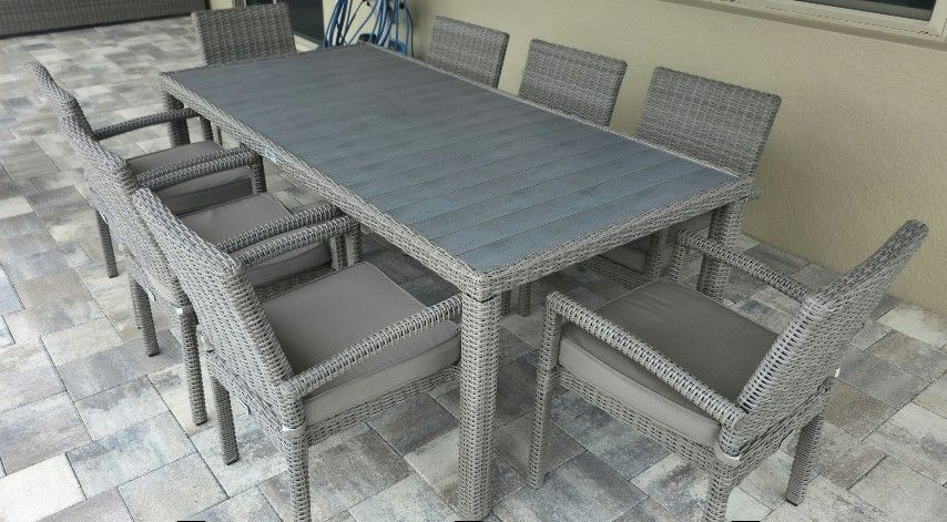 High End Brown/Gray Vinyl Plastic (Metal Framing) Wicker Table With 8 Chairs Outside