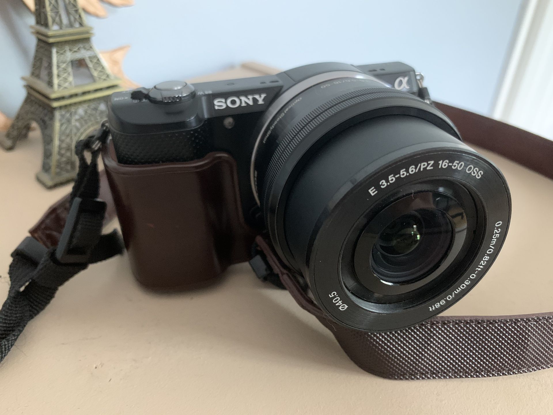 Sony a5000 with 16-50mm lens and vintage leather case