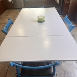White Dining Table with 4 Blue Chairs