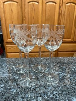 Set of 4 Crystal wine glasses with pretty etched design.  Size approximately 7 1/2 inches tall. Capacity 6 ounces.  Brand new never used.  Has been on