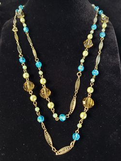 $10. 1928 Brand gold tone blue and green and silver glass bead necklace. 46 inches long.