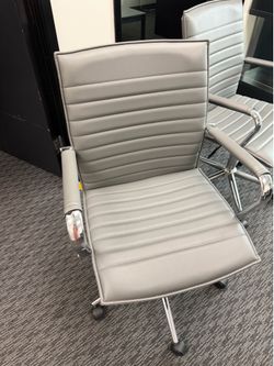 Grey rolling office chairs with leather like padding
