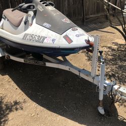 Jet ski and trailer.   As is