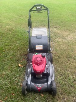 Self-propelled gas lawn mower with an electric start ignition system