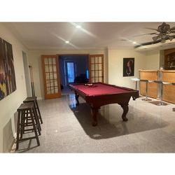 Pool Table With 2 Wooden Stools And Painting 