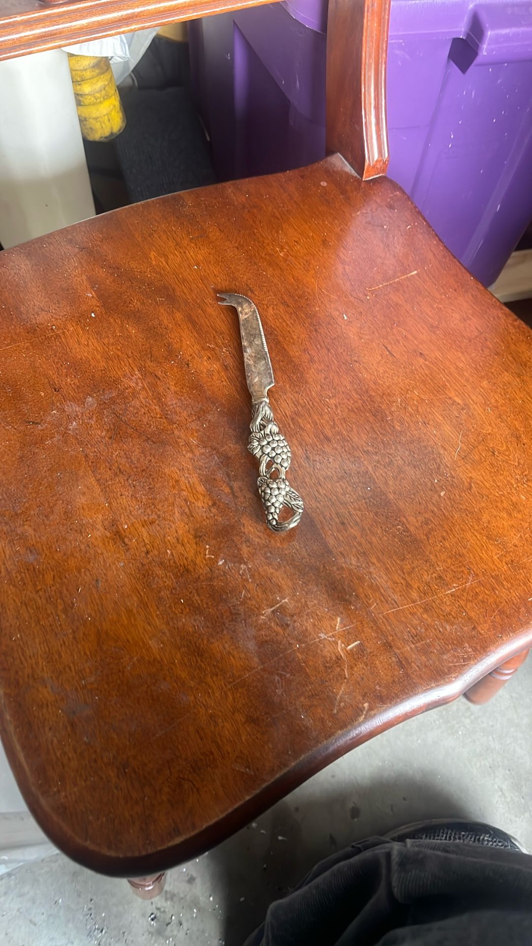 This is a vintage silver-plated cheese knife with a grape vine design on the handle. It is often sold as a single item or as part of a set of cheese k