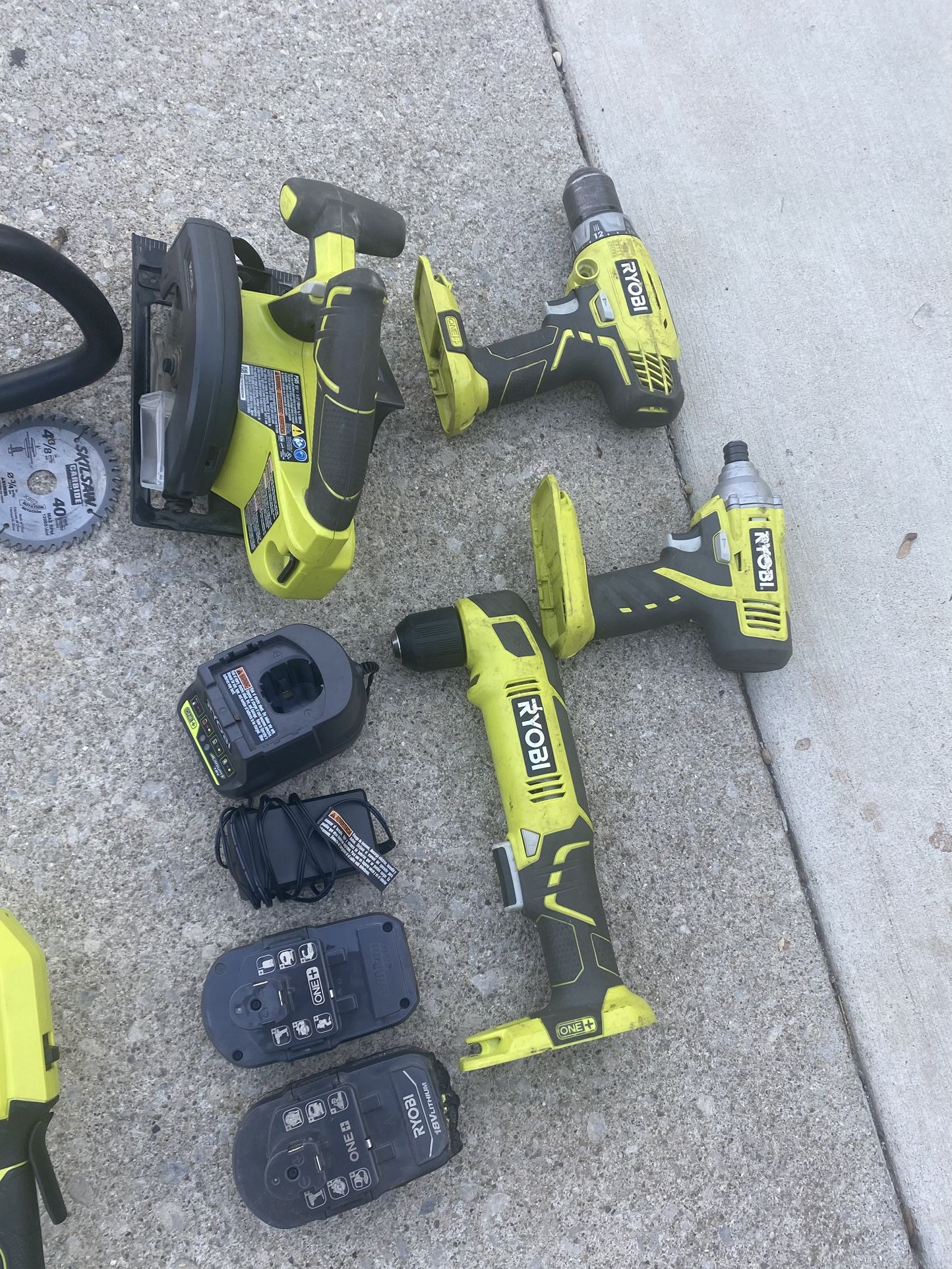 RYOBI ONE+ 18V cordless tool system. The main tool is a string trimmer/edger, and a circular saw, a drill/driver, and a right-angle drill, along with 