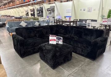 Black  sectional sofa with ottoman fur- like jumbo corduroy