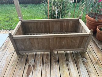 A Teak wood above ground planter box, vegetable garden container