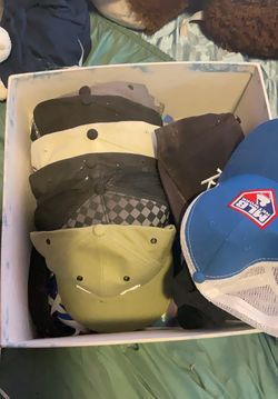 A bunch of football/baseball hats