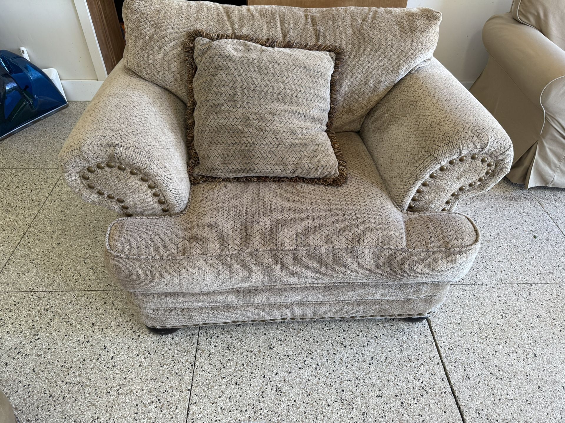 Extra comfy oversized chair with matching ottoman in neutral tan chenille fabric.