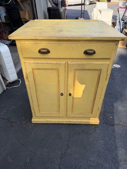 Cute yellow cabinet with drawer