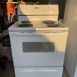 Whirlpool electric range oven and matching white GE over-the-counter microwave combo