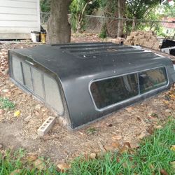 black camper with plastic cover measures 98-70 