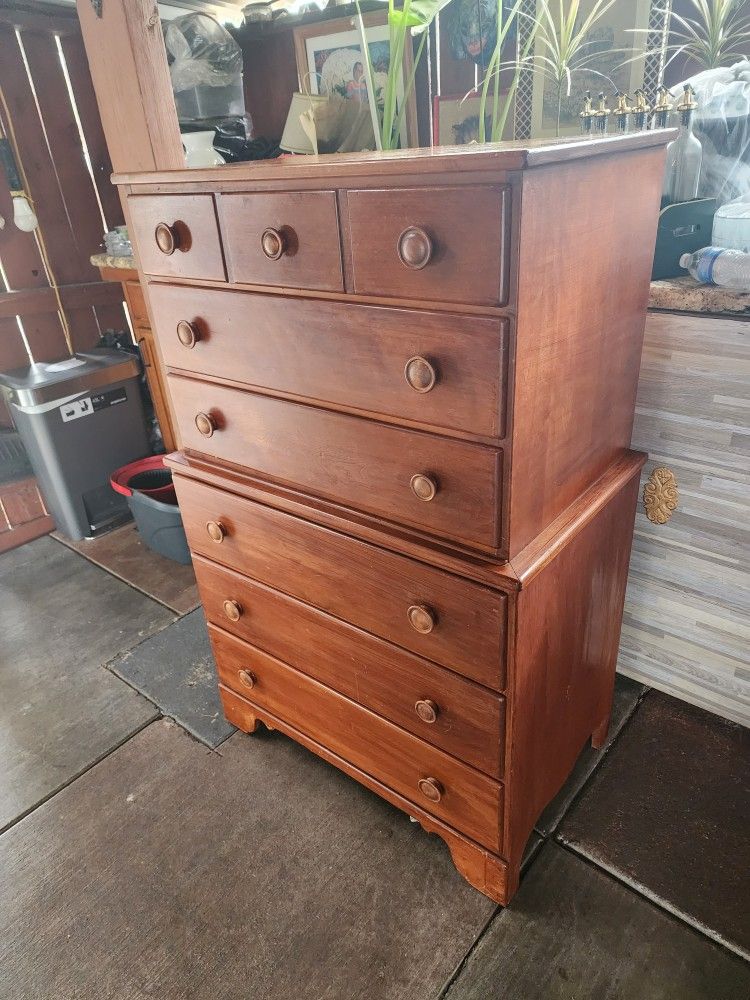 Solid wooden dresser with multiple drawers.