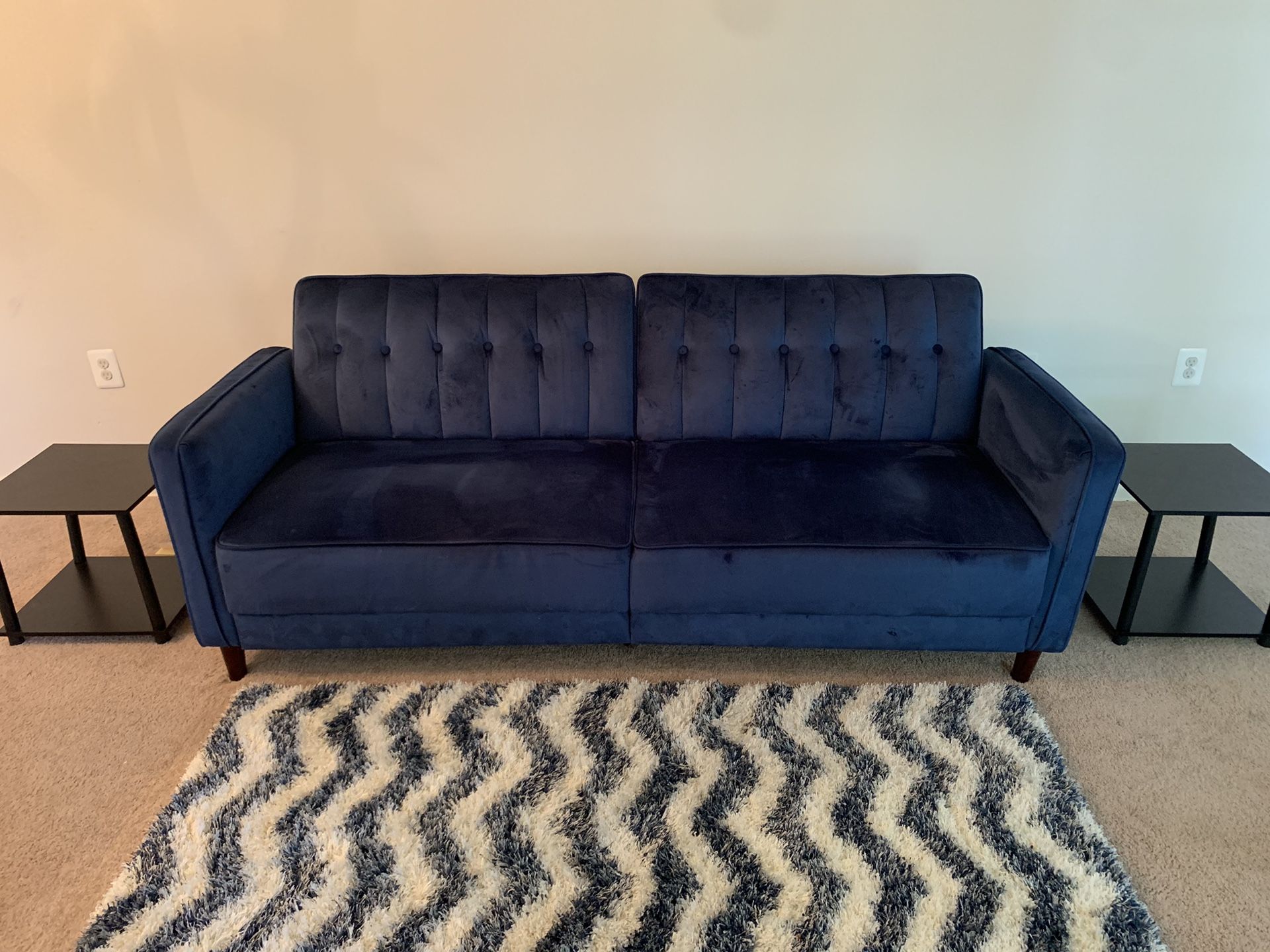 Blue velvet couch with two side tables