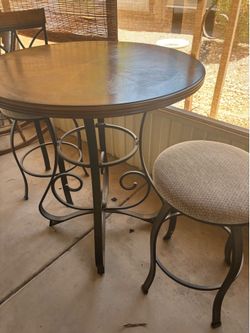 Bar height, wood table and chairs. In great shape all metals.