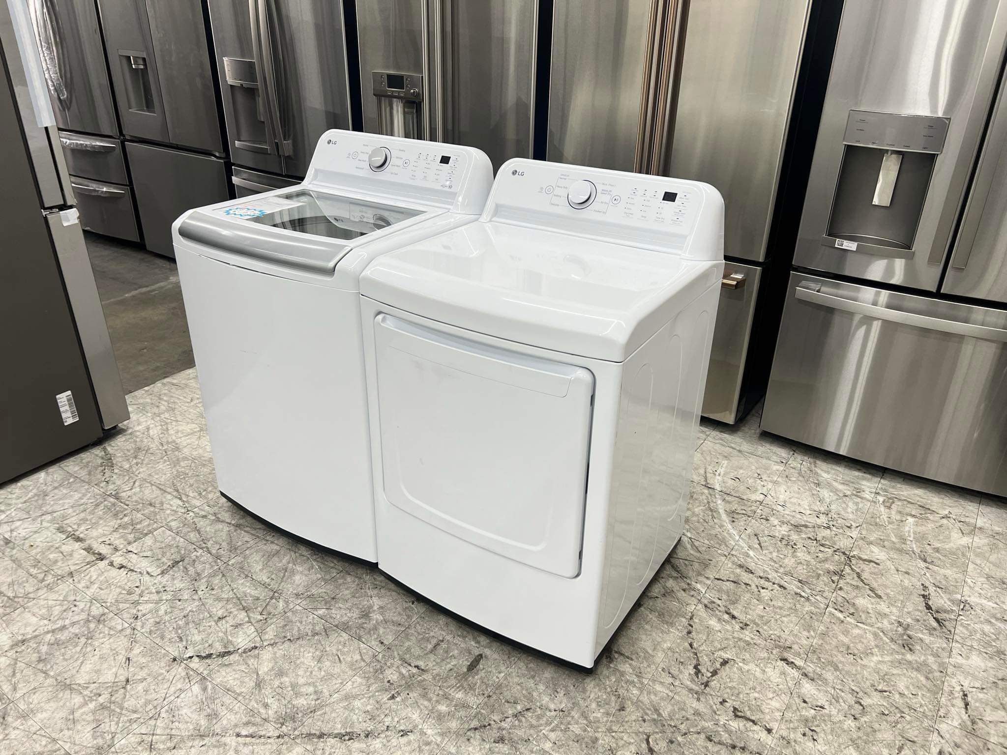 LG high efficiency top load washer and gas dryer in white 