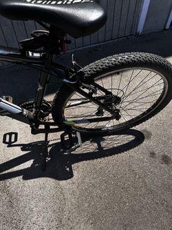 This is a 26-inch Schwinn Ranger black mountain bike with 21-speed Shimano gears.