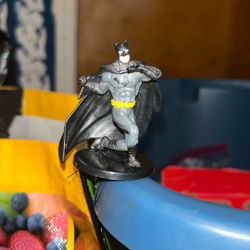 Two small batman figurines, one damaged 