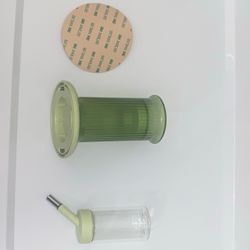 Small green animal, water dispenser, hamster