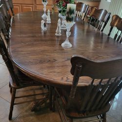 Large, dark oak table to leaves only one showing in the picture.I have the other 18 chairs, very, very heavy.Twelve hundred dollars are very close off