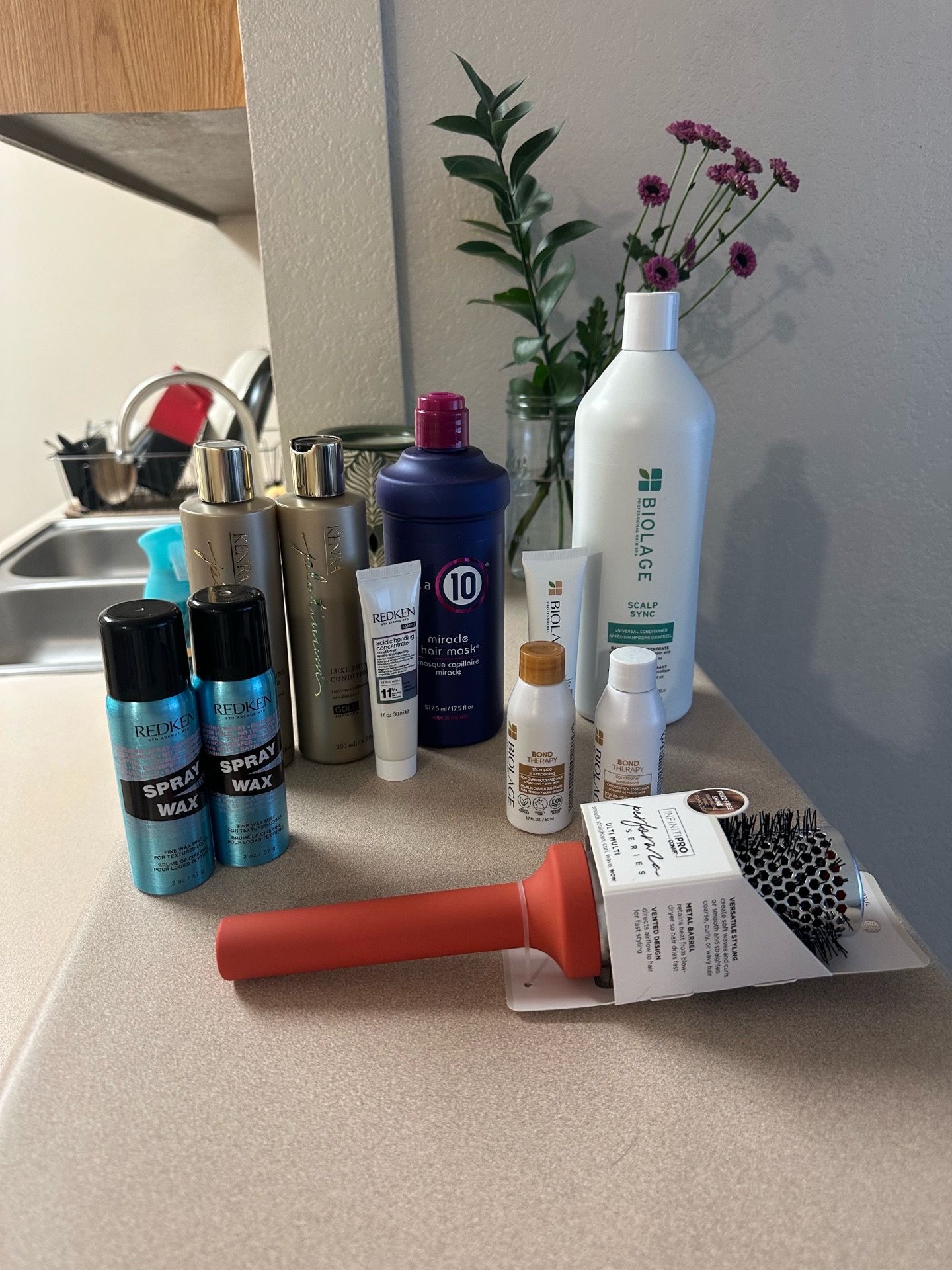 Assortment of shampoo and conditioners plus hairbrush Assortment of shampoo and conditioners plus hairbrush