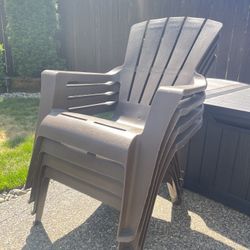 Four Brown Outdoor Adirondack Chairs