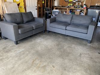 Dark gray couch & loveseat w nail head trim