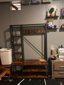 wooden shelves with black bars, and five coat hangers
