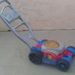 Toy Lawn Mower for Kids, Multi-Color with Big Wheels & Center Spinning Action, Well Used But Still Functional Providing Fun Times for Your Little Ones