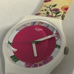 Swatch Fiorinella SUOW127 watch with a pink dial and a white floral strap. 