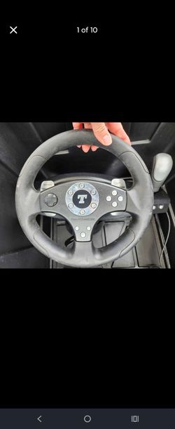 Thrustmaster RGT Force Feedback Clutch V.1. ThrustMaster Steering wheel, peddles, and a monitor.