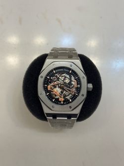 154000R.OO.12200R.01 Rose gold skeleton watch with mechanical movement, luxury timepiece with polished finish and gold accen