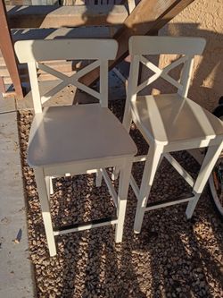 Pub height white wooden chairs