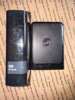 A hand full of older external hard drives