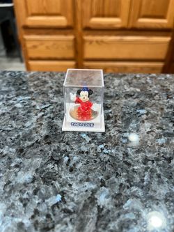 Disney Small Mickey Mouse Sorcerer 1 inch tall figure in a plastic case.  Preowned it’s been on display in a cabinet.
