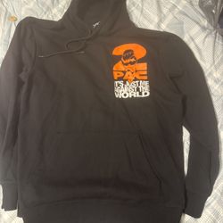  black 2Pac hoodie featuring an orange and white graphic of the slogan "It's Just Me Against the World. SIZE LARGE 