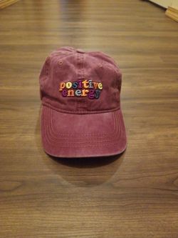 Maroon  Baseball cap that says positive energy