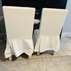 White pleated Napoli dining chair with a slipcover.