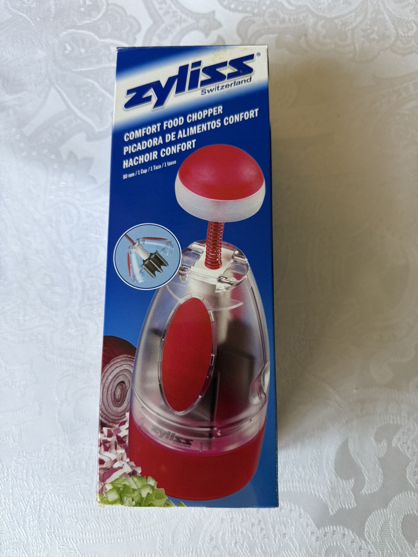 Top brand Zyliss Comfort Food Chopper from Switzerland. Dishwasher safe. New. Still in box. Features a unique comfort top, automatically rotating stai