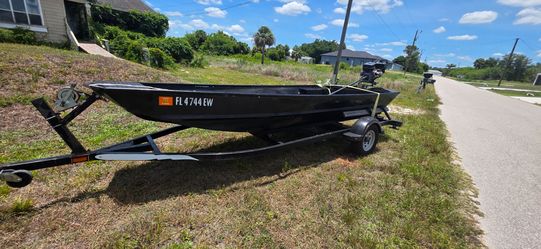 16 ft jon boat with trailer and mud motor.
