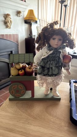 Collectible doll with fruit cart