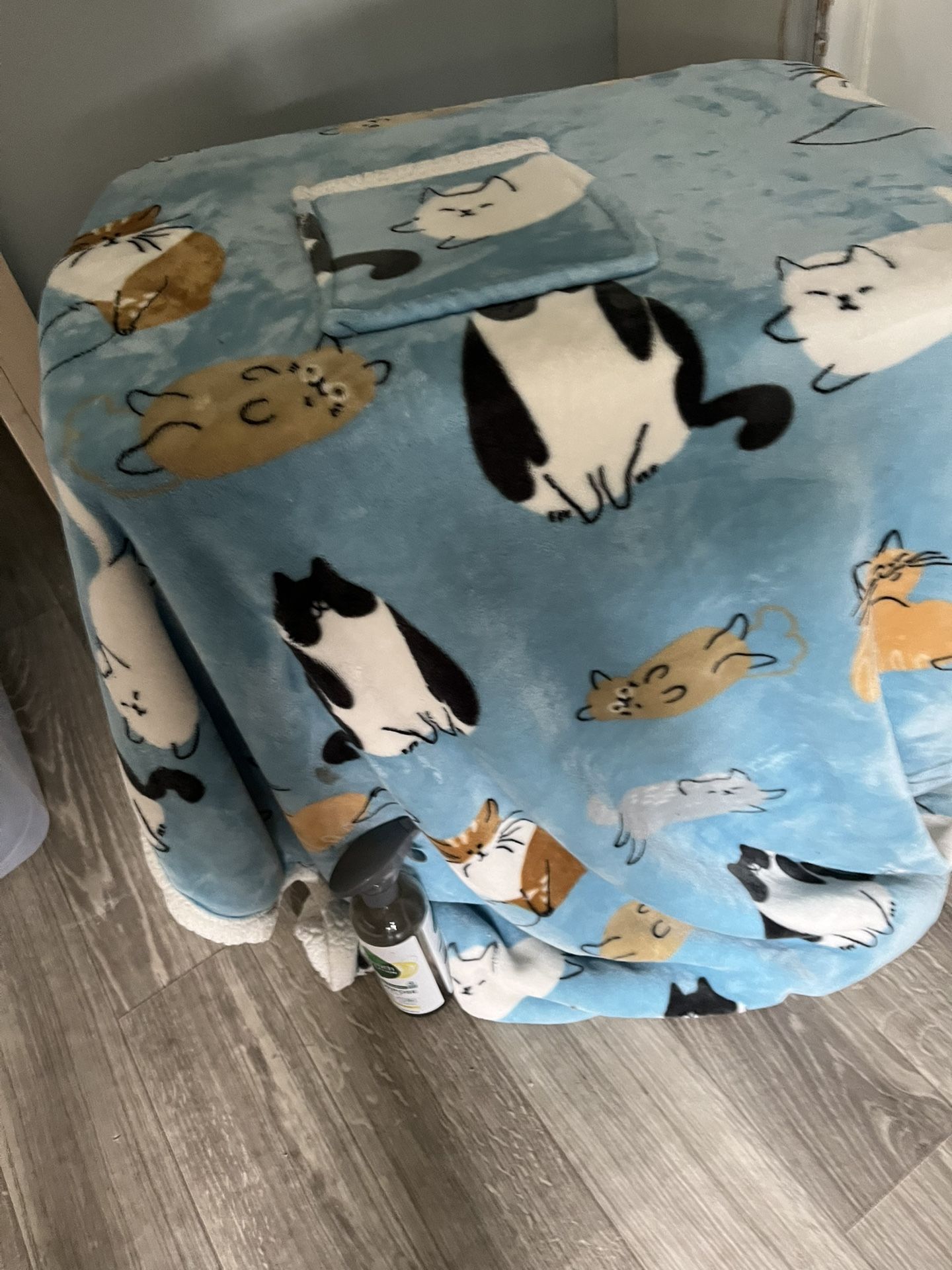 A Snuggle Blanket With Arms And A Front Pocket