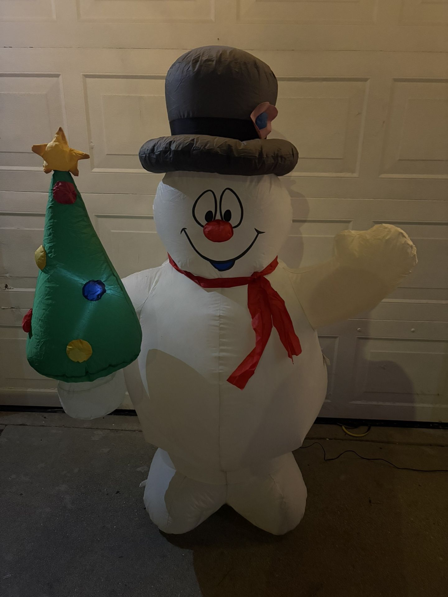 This is a Gemmy Airblown Inflatable Frosty the Snowman holding a Christmas tree