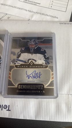 Two Connor hellebuyck, one autograph one rookie jersey card