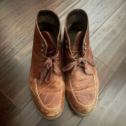 Four pairs of mens Nike shoes and one pair of brown casual boots