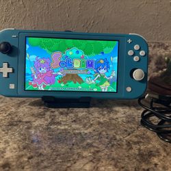 NINTENDO SWITCH LIGHT WITH A GAME AND USB  CHARGER CORD AND HOLDER INCLUDED / WORKING GREAT