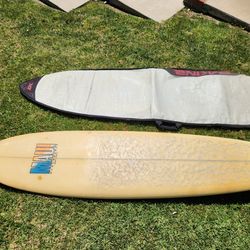 Maui and Son's original 7'6" tri fin surfboard with DaKine board bag